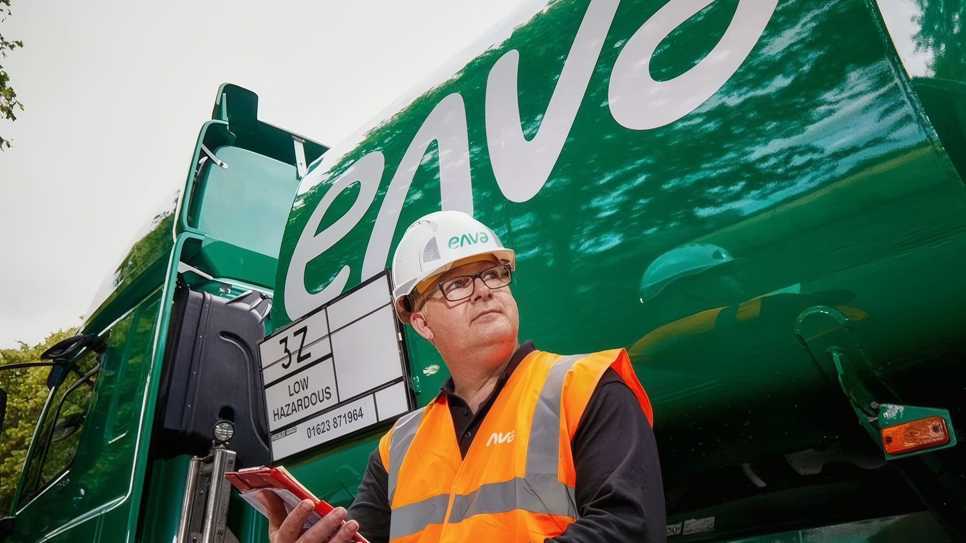 Workman stands in front of an Enva truck
